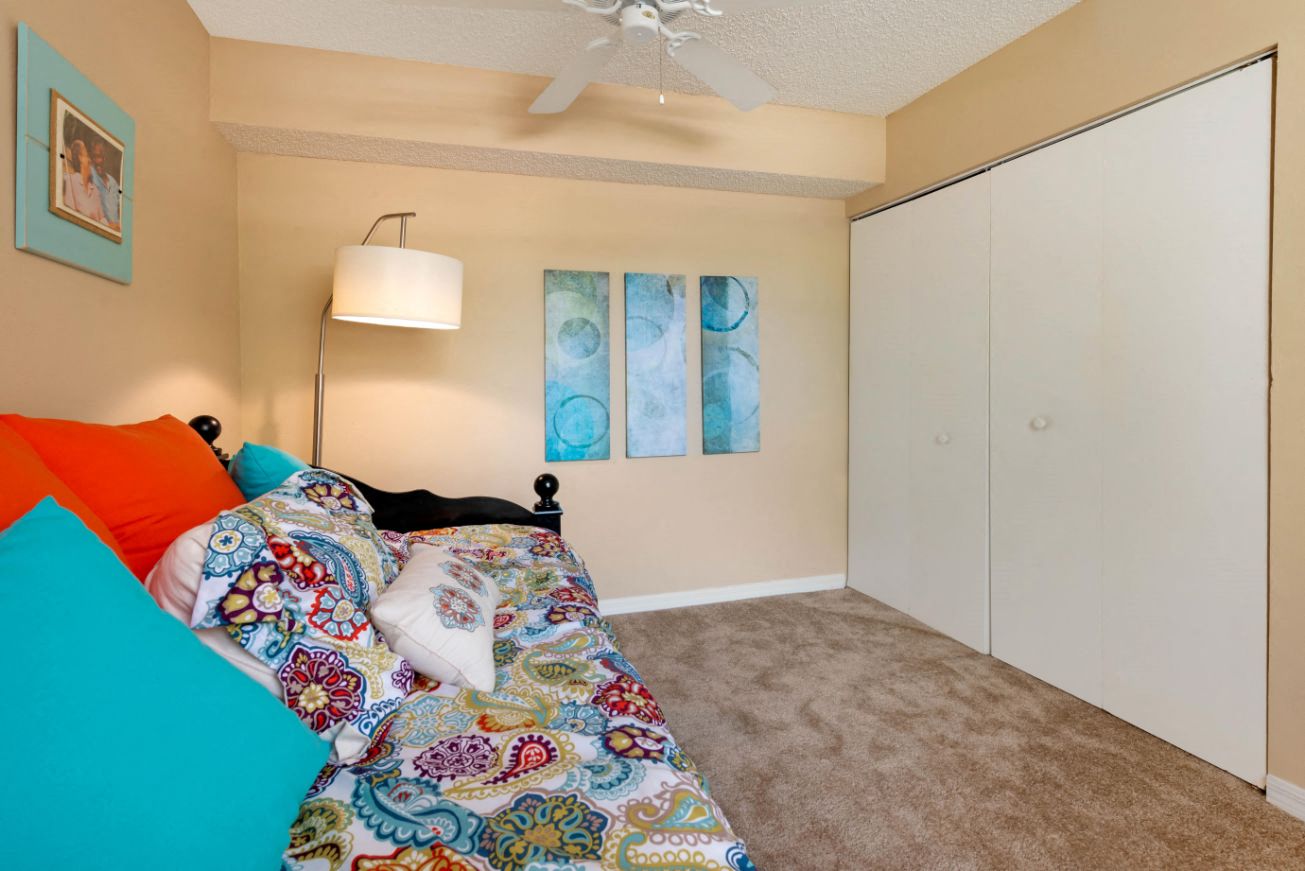 Furnished Carpeted Bedroom with Large Sliding Closet