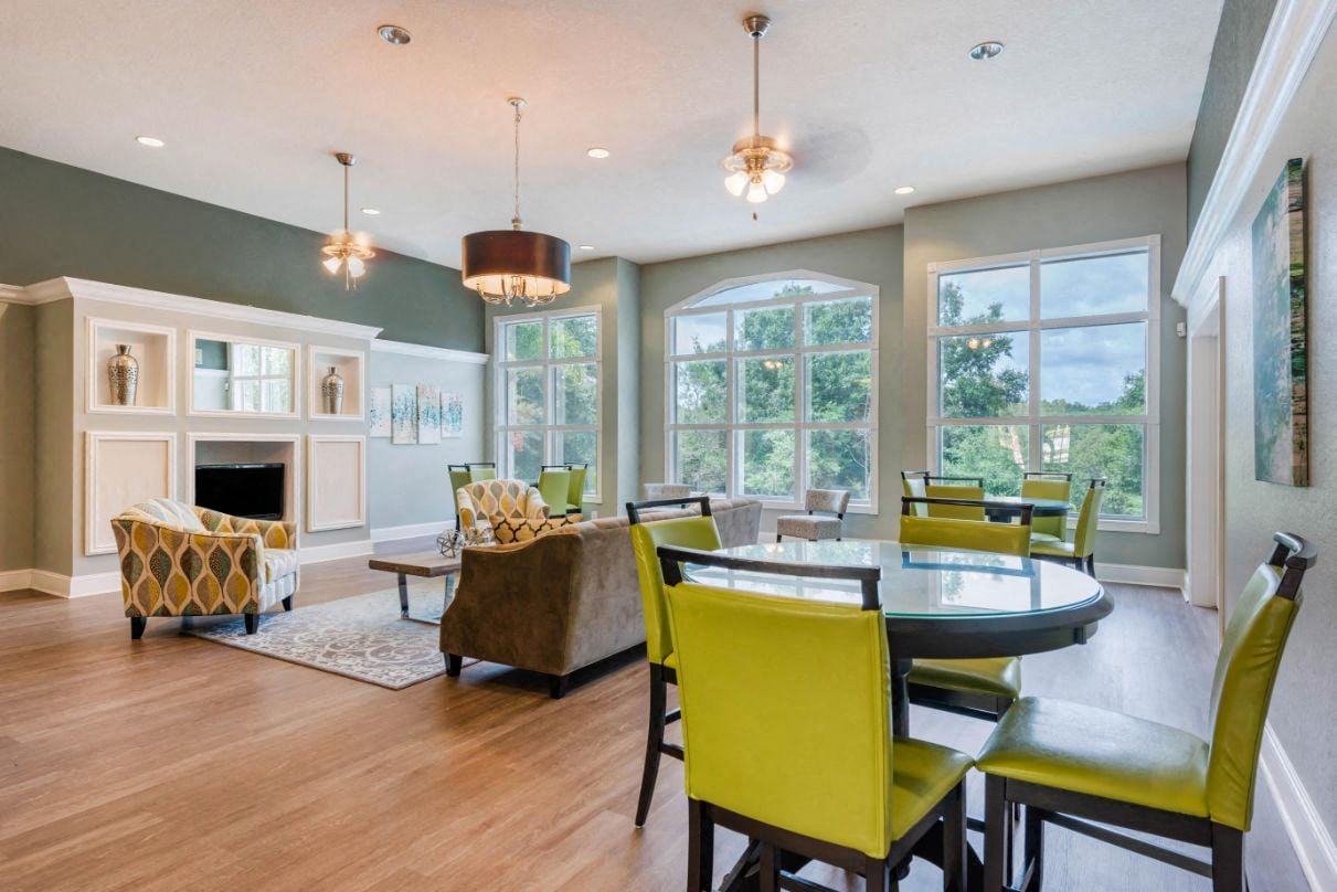 A dining room with a table and chairs.