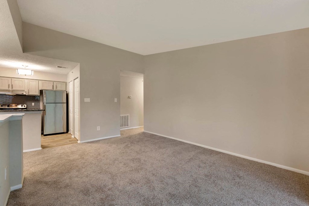 Carpeted Open Floor with Kitchen with Stainless Steel Appliances
