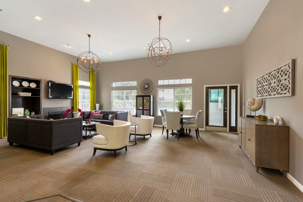 Clubhouse with Contemporary Fixtures and Decorations and Dining Table with Chevron Print Chairs Next to White Armchairs