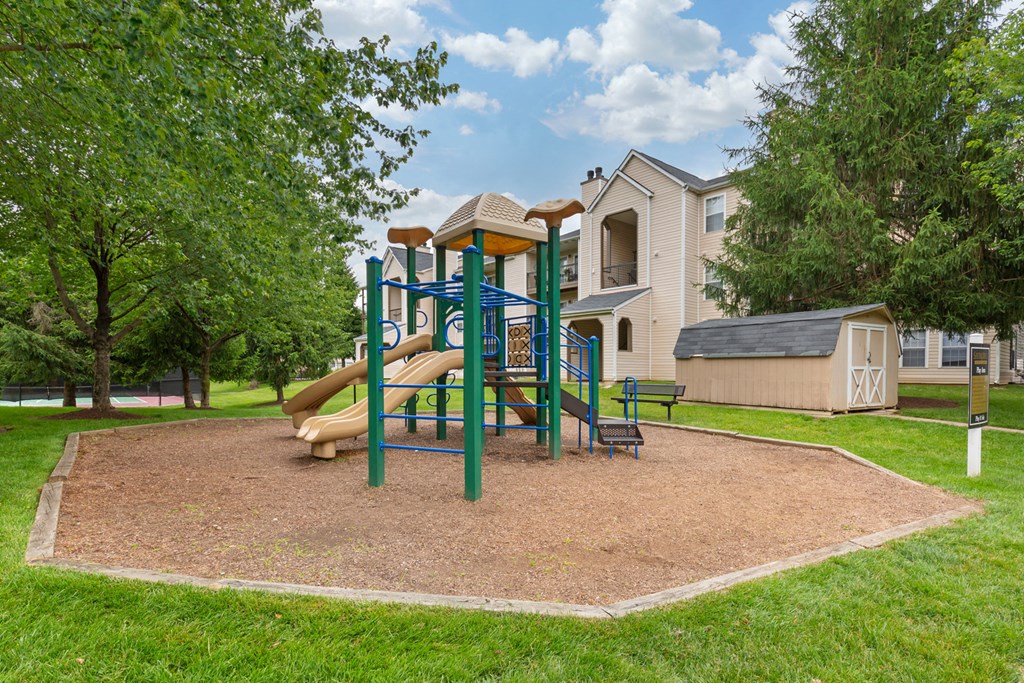 Playground on wood clips surrounded by building exteriors and trees