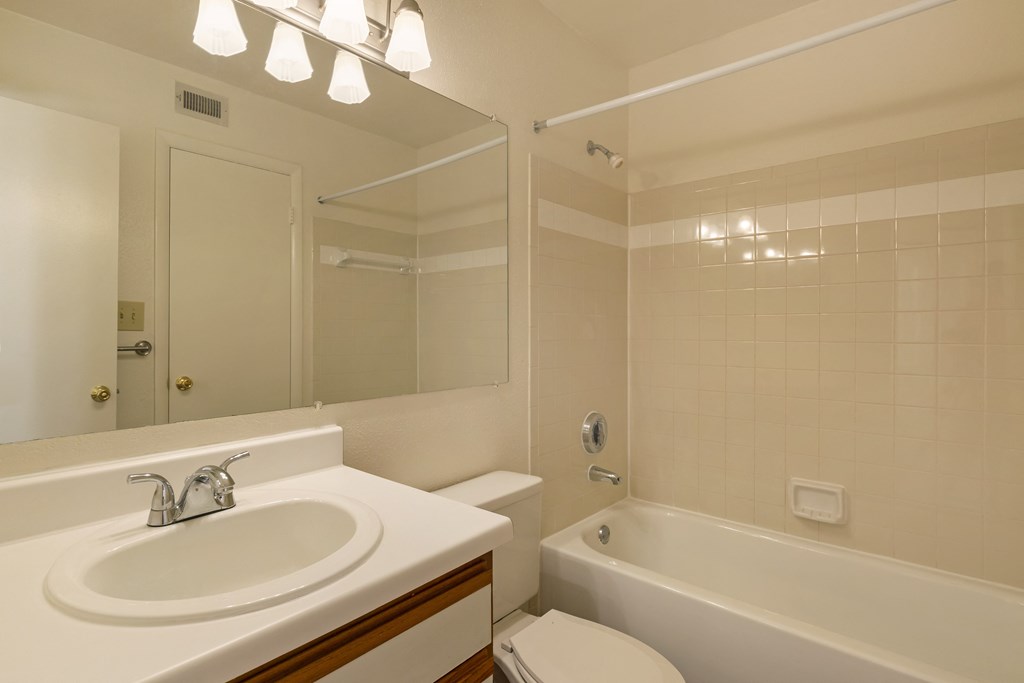 a bathroom with a sink toilet and bathtub