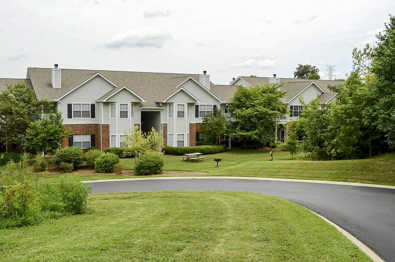 a large grassy area with a house in the background
