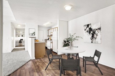 A modern kitchen with a dining table and chairs.