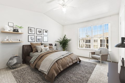 Spacious bedroom with vaulted ceiling and large window at Tierra Antigua Apartments, Mesa, AZ