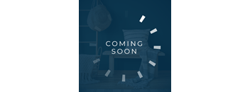 A room with a chair, a sofa, and a lamp with a "Coming Soon" sign.