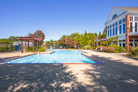 a swimming pool with a blue building in the background