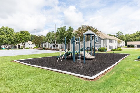 A playground with a slide and a green roofed structure.