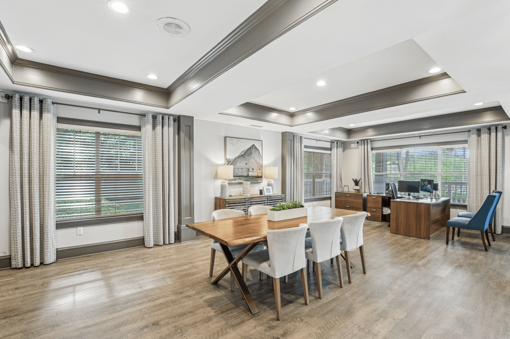 clubhouse with table seating and computers in the background