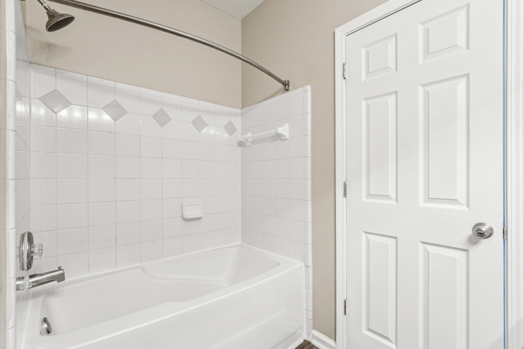 bathroom with shower and bathtub