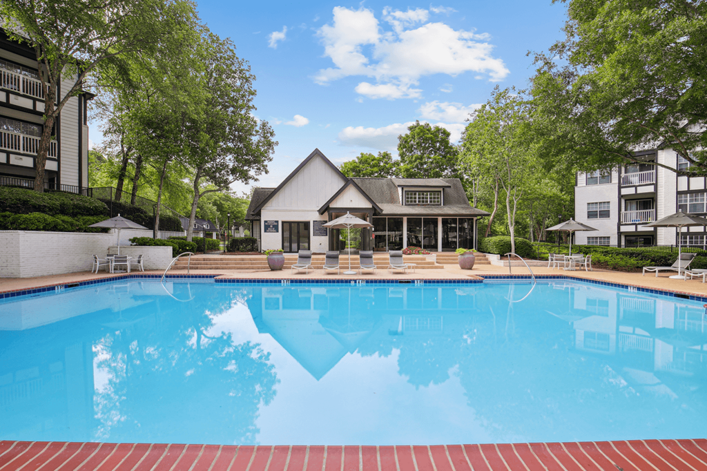 swimming pool with clubhouse in the background