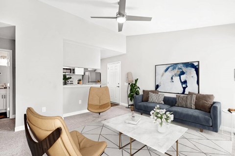 a living room with white walls and a gray couch