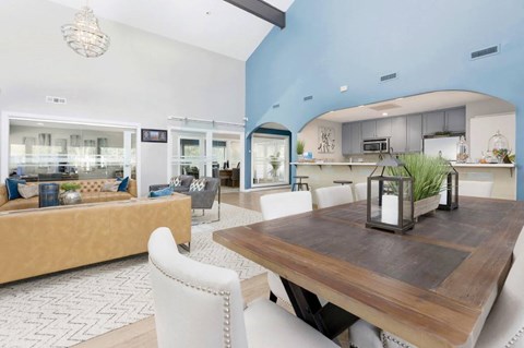 A modern dining room with a wooden table and white chairs.