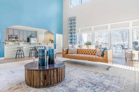 A modern living room with a wooden coffee table and a yellow sofa.