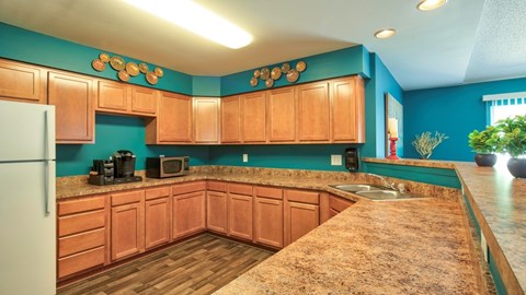 A kitchen with wooden cabinets and a granite countertop.