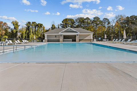 Swimming pool area facing the resident clubhouse with natural landscaping