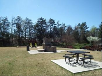 A picnic table is surrounded by a white square with a black border. at Eastchester Ridge Apartments, High Point, North Carolina