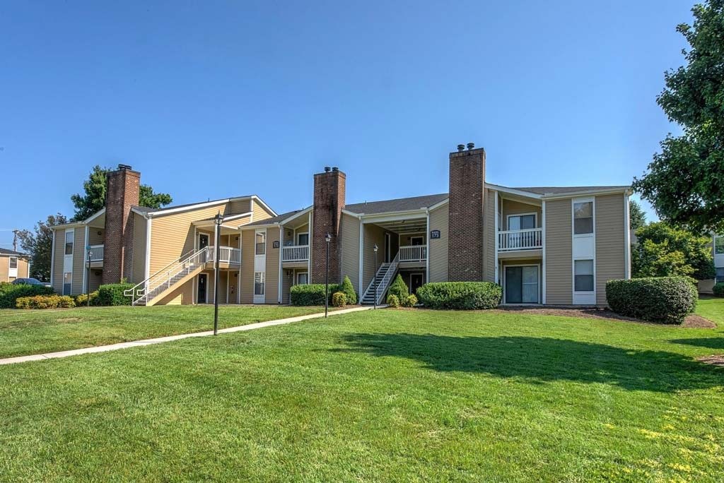 Apartment complex with a green lawn in front at Fox Hollow Apartment Homes, High Point, 27265