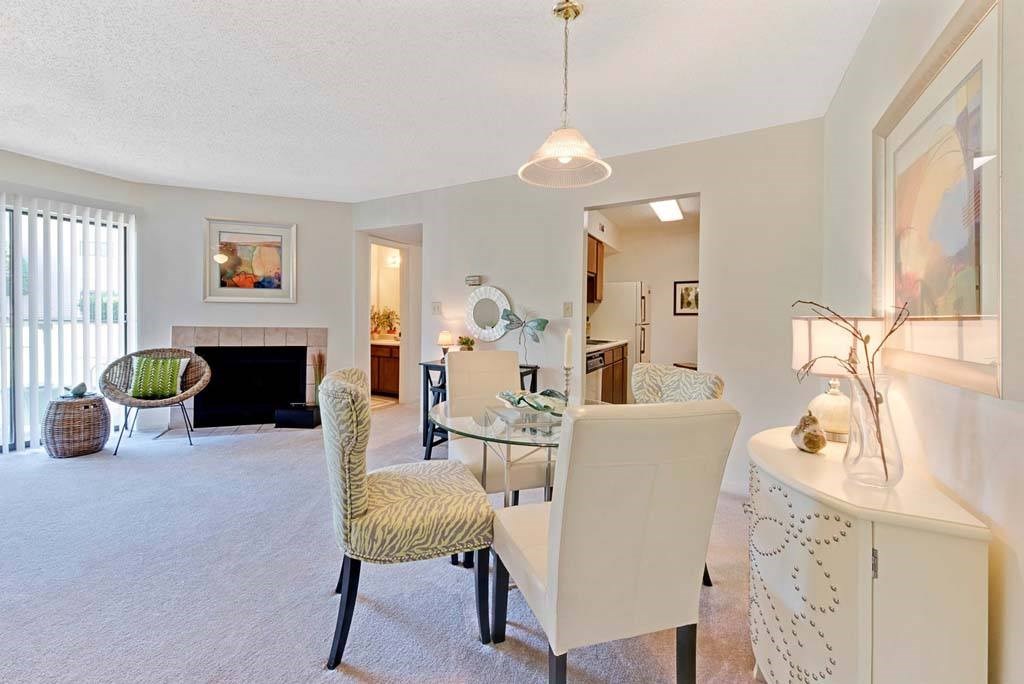 A living room with a fireplace and a chair at Fox Hollow Apartment Homes, High Point, North Carolina