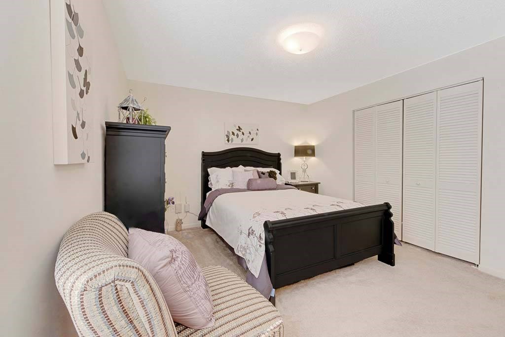 A bedroom with a bed, a dresser, and a couch at Fox Hollow Apartment Homes, North Carolina