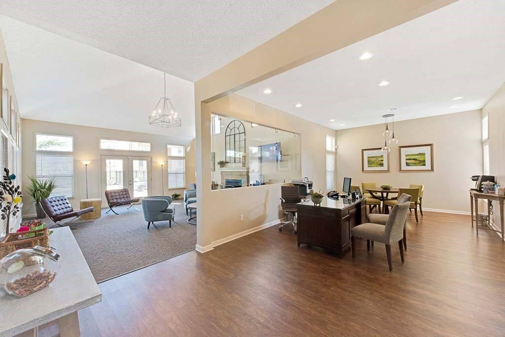 A spacious living room with a dining area and a kitchen in the background at Fox Hollow Apartment Homes, High Point
