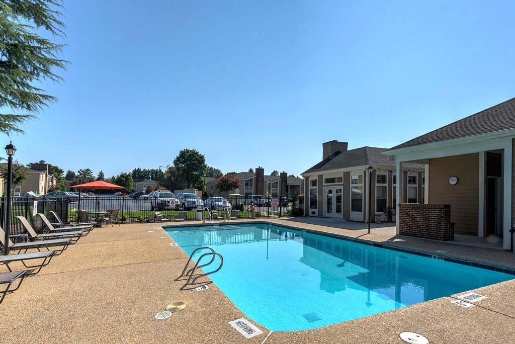 A pool with a blue tiled edge and a white pool marker at Fox Hollow Apartment Homes, High Point, North Carolina
