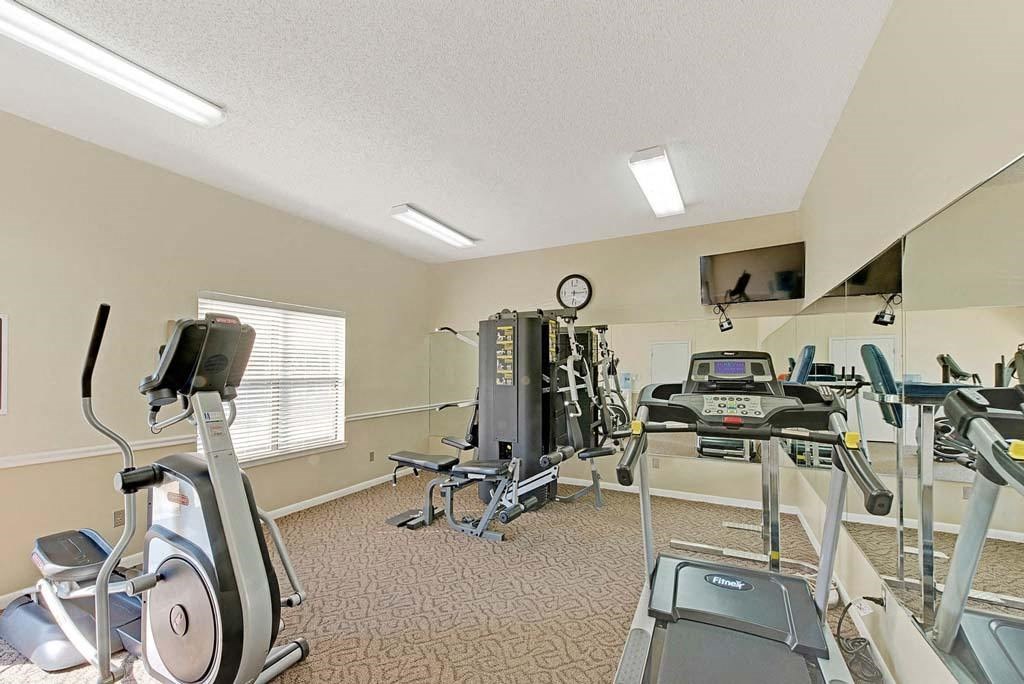 A well-equipped gym with treadmills, elliptical machines, and other exercise equipment at Fox Hollow Apartment Homes, North Carolina, 27265