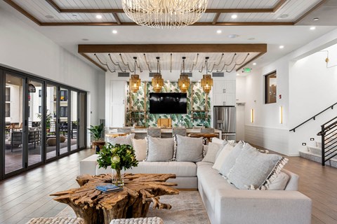 A living room with a white couch and a wooden coffee table.