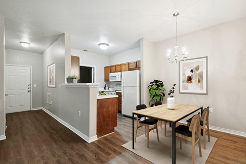 A kitchen with a table and chairs in the middle of the room.