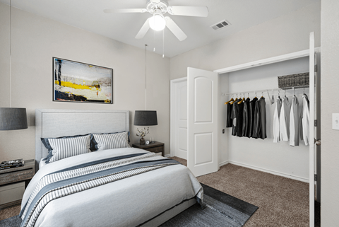 A bedroom with a large bed and a painting on the wall.