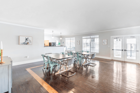 A dining room with a table and chairs.