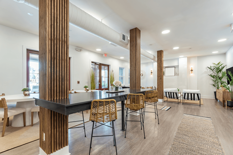 A modern dining room with a long table and chairs.