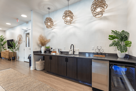 A kitchen with a black counter top and a white wall.