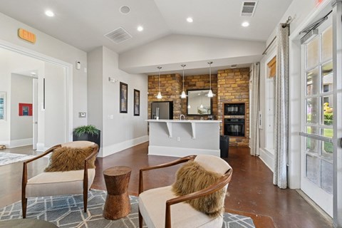 A living room with a brown chair and a brown ottoman.
