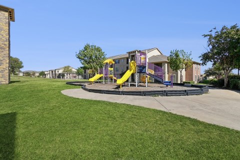 A playground with apartments in the background