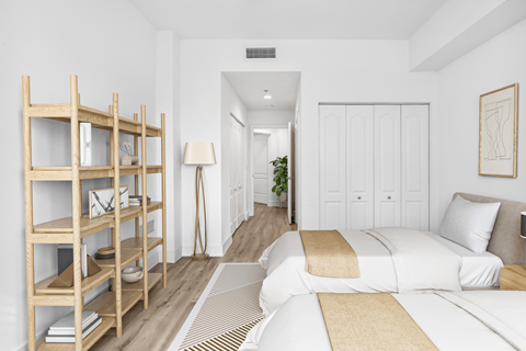 a bedroom with a large bed and a book shelf