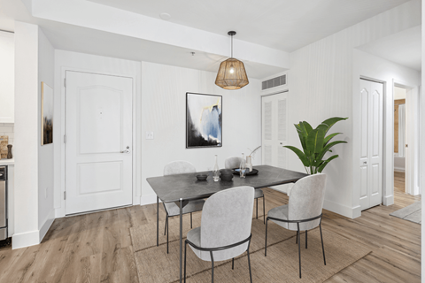 a dining room with white walls and a table and chairs