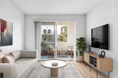 A living room with a grey sofa, a coffee table, a television, and a painting on the wall.