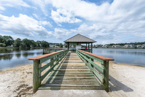 A wooden pier with a gazebo at the end.