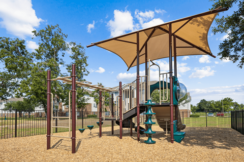 a playground with a swing set and a slide