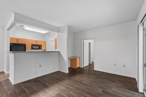 a living room with a view of the kitchen