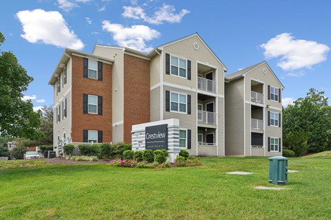 A CrestView apartment complex with a green lawn in front.