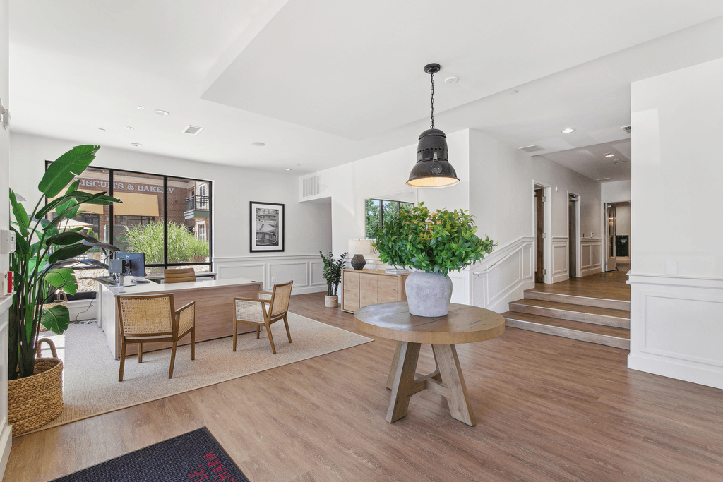 a view of the lobby of a hotel with a table and chairs