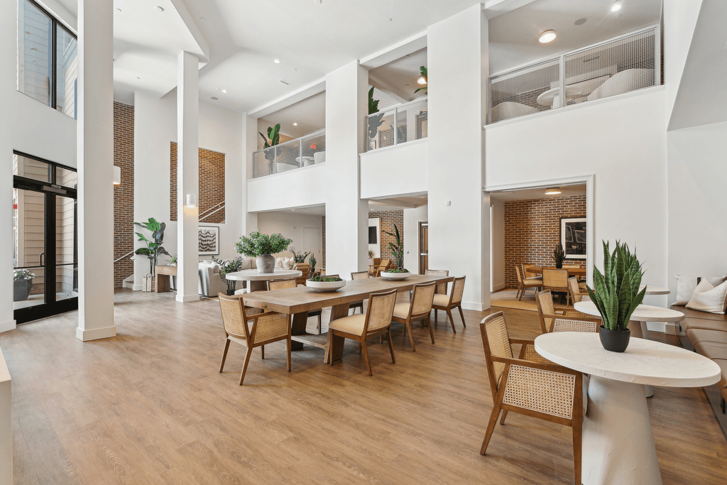 a living room and dining room with a large table and chairs