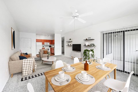 Open concept dining and living area with wood table at ReNue Downtown Apartments, Phoenix, AZ 85007