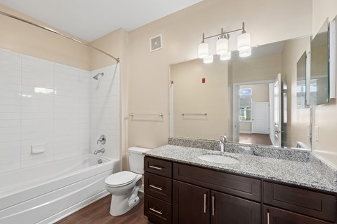 A bathroom with a white toilet, a white sink, and a white bathtub.