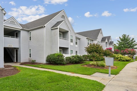 A row of houses with a sign in front of them.