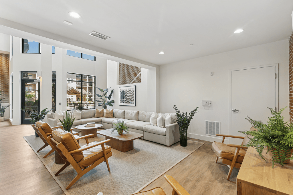 a living room with a couch and chairs and a table