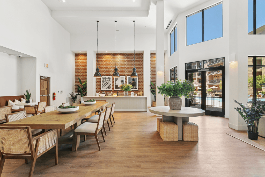 a large dining room with a long wooden table and chairs