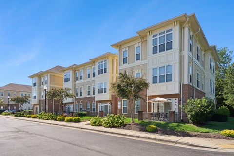 A row of townhouses with a clear blue sky above them.